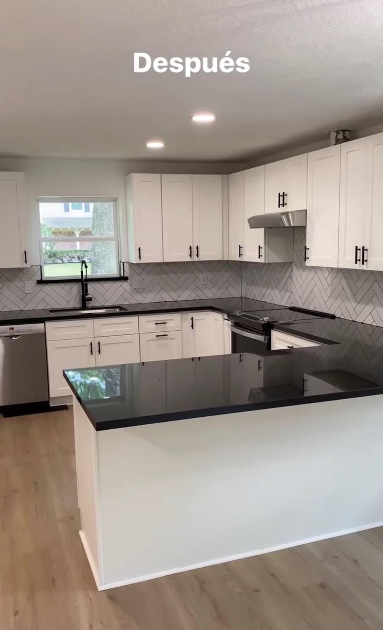 Finished kitchen remodel — white shaker cabinets, black granite countertops, herringbone tile